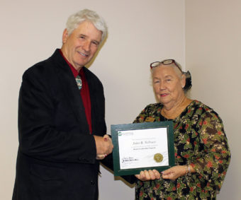 Mohave Electric Cooperative Board of Directors Lyn Opalka, presents the accredited NRECA Board Leadership Certificate to John Nelssen. 