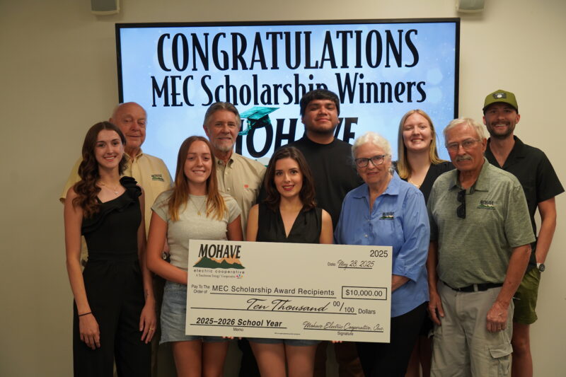 Group of people holding a large check representing the MEC scholarship