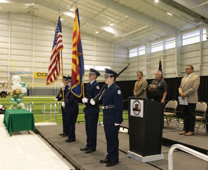 men in uniforms holding flag