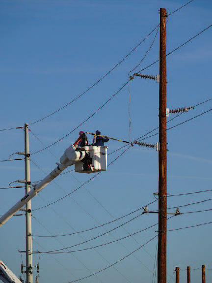 lineman in bucket truck working on power pole