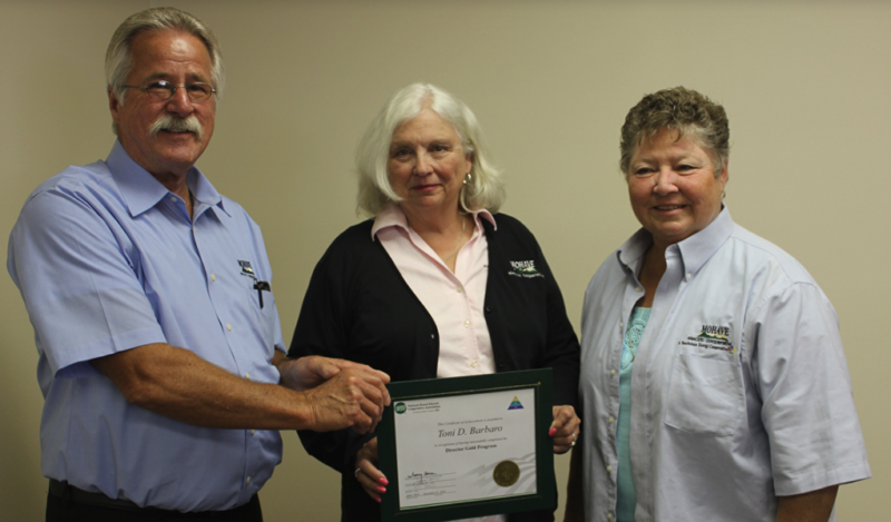 Board Director Cindy Christy joins Director Joe Anderson as he presents the Gold Director Certificate to fellow Director Toni Barbaro.